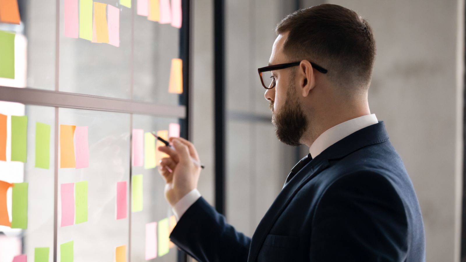 Business owner writing on a post-it note